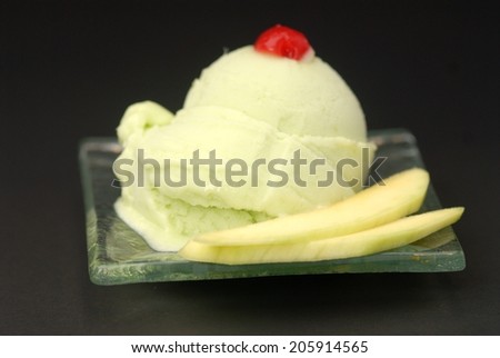 Serving of frozen homemade creamy ice yogurt with fresh mango and wooden spoon,Mango and pineapple sorbet or ice cream for Christmas
