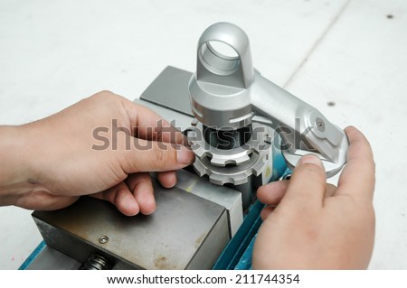 Auto mechanical engineer adjusting a car shock absorber in car service workshop,Hand man repair motorcycle during day,Motorcycle mechanic,Technician