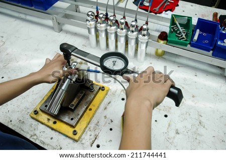 Auto mechanical engineer adjusting a car shock absorber in car service workshop,Hand man repair motorcycle during day,Motorcycle mechanic,Technician