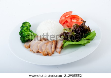 Roast pork sliced on a plate,Crispy roasted belly pork chinese style and rice,Char Siu Pork - Chinese roasted pork loin served in a bowl of steamed rice.