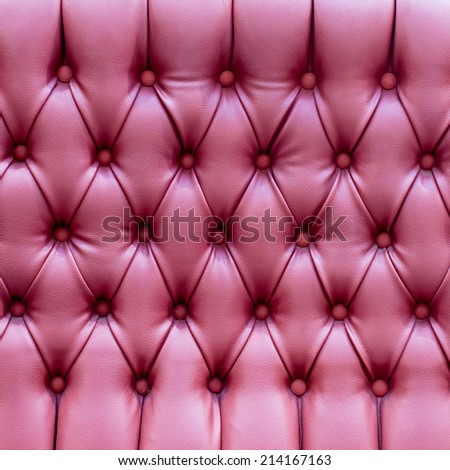 Closeup texture of vintage red leather sofa for background,Luxurious red-tone leather texture furniture with buttons