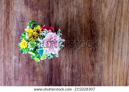 bouquet of roses on wooden table,Wedding bouquet of yellow and white roses and blue fresia lying on wooden floor