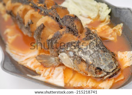 Sour soup made of tamarind paste with fish,Sour curry with deep-fried snake headed fish