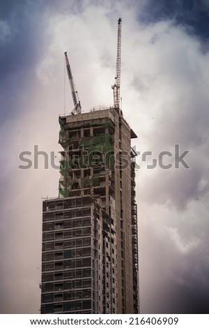 Inside place for many tall buildings under construction and cranes under a blue sky,building under construction in a new residential area of Milan