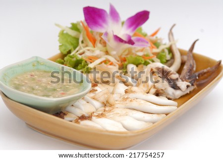 Grilled squids with chili sauce.,Grilled squid and spicy sauce on