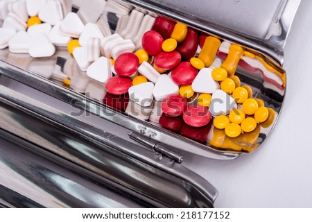 pills in pill counting tray,Red tablets medicine on the drug count tray,Yellow tablets medicine on the drug count tray ,White tablets medicine on the drug count tray