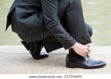 Lace shoes,A businessman is lacing his shoes,groom putting his wedding shoes. Hands of wedding groom getting ready in suit