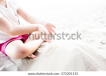 Children\'s play sand, Young girl molds of sand on the beach.