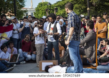 ISTANBUL/TURKEY -Â?Â? MAY 18 2014: Syrian Demonstrators perform short sketch that illustrates Bashar Al-Assad's attachment to the presidency, and how far he will go to keep it.