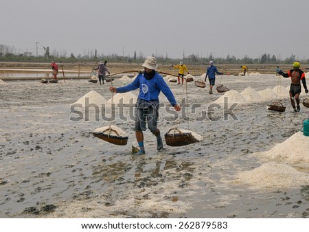 PETCHABURI- MAR 21 :  Workers are helping to transport salt from salt. Ban Laem, Phetchaburi, Thailand on March 21, 2015