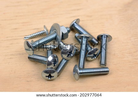 bolt and nut on wood background