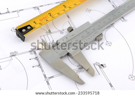 vernier caliper and measuring tape on plans