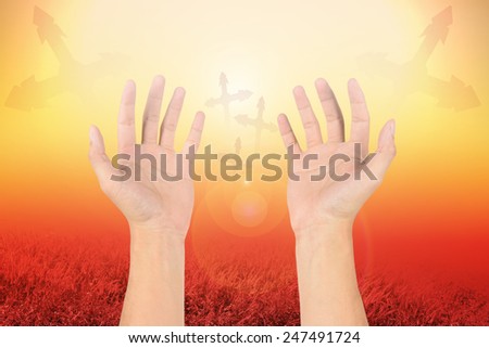 hand reaching for the cross on filters nature background