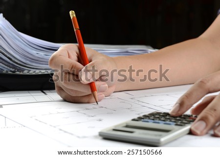 working man, working hard, typing calculator and writing