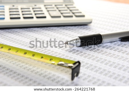 Focus pen, calculator and pen and measuring tape on sheet number
