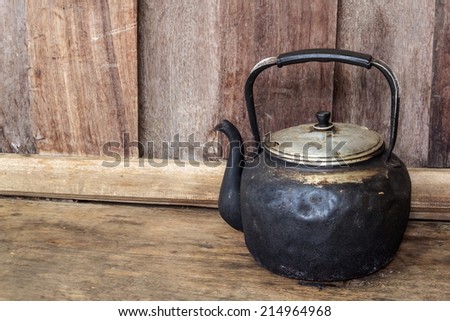 Old black kettle, Old black kettle on wood background.