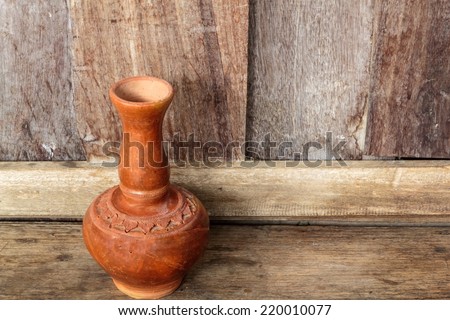 Old clay ceramic vase, Old clay ceramic vase in wooden background.