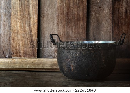 Pot, Cooking black pot on old wooden table.