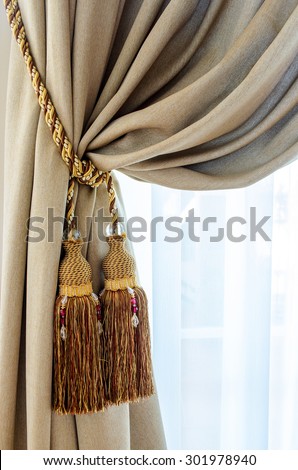 Dual tassels on curtain at main window