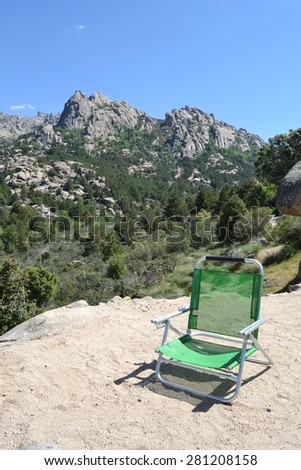 mountain, green chair in foreground