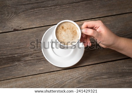 Woman holding white coffee mug. Warm mug in womans hand.