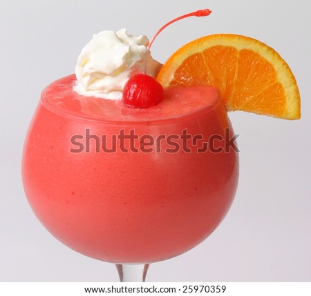 Frozen drink garnished with fruit and whipped cream.