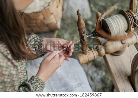 Close-up of hands of a woman traditional wool spinning.