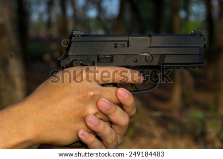 the gun in hand