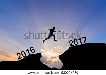 man jump between 2016 and 2017 years on light sunset background.