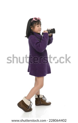 Little asian girl holding mirror less camera on white background isolated