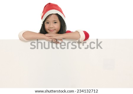 Beautiful asian girl in santa hat and red comforter behind white board onwhite back ground isolated