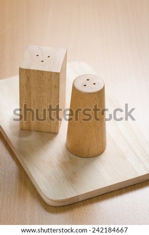pepperbox  and salt cellar on wooden table background