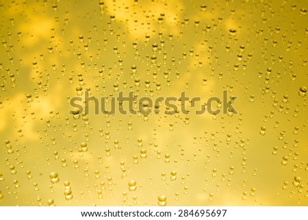 Gold water drops on mirror background
