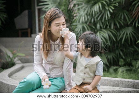 Happy asian family in a park,Asian mother and son smiling