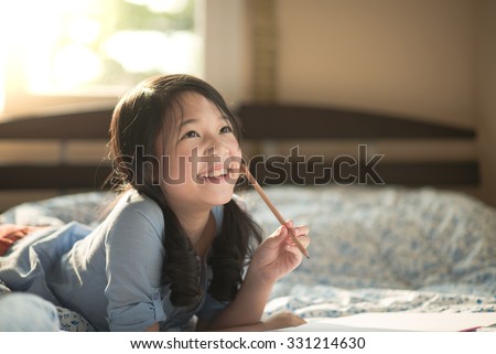 Beautiful asian girl thinking on the bed