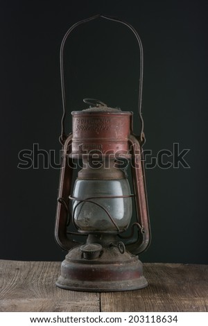 Old oil lamp on dark background.