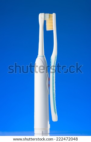 Electric toothbrush and usual toothbrush in love mood.