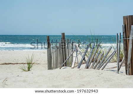 Broken fence on a beach near the ocean