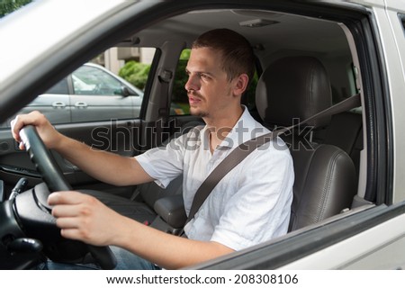 Young caucasian driver goes by rules and safe