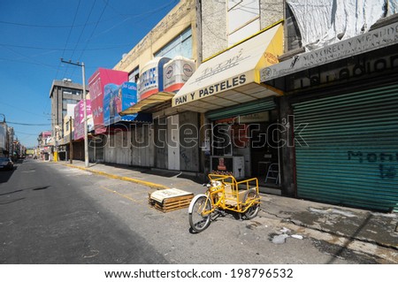MEXICO CITY, MEXICO - OCTOBER 7, 2012 : A street in the historic centre of Mexico City, Mexico. Centro Historico is the main neighborhood in the city. Unrecognizable people visible in the background.
