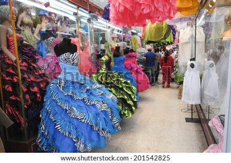 MEXICO CITY, MEXICO - OCTOBER 7, 2012  A shop  in the center of Mexico City, Mexico with traditional dresses for the celebration of a girl\'s fifteenth birthday. People visible in the background.