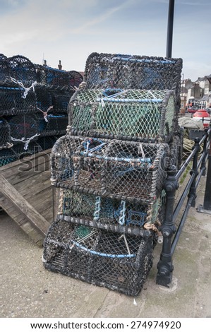SCARBOROUGH, UNITED KINGDOM - MARCH 22, 2015 Crabs and lobster net covered trapping pots stacked at Sarborough.