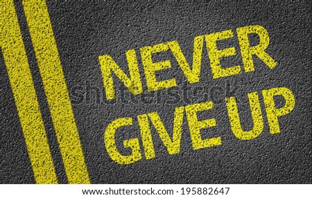 Never Give Up written on the road