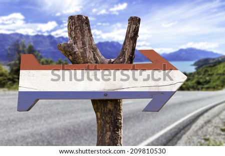 Netherlands wooden sign with a street on background