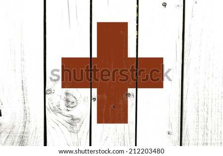 Red Cross flag on wooden background