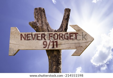 Never Forget 9/11 wooden sign with sky background