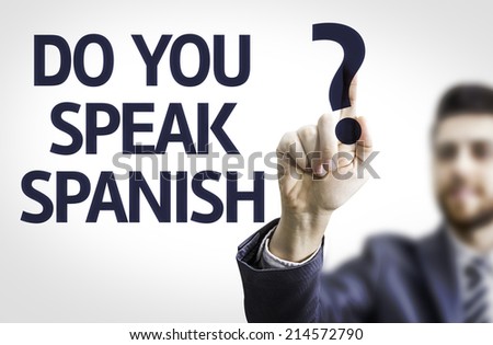 Business man pointing to transparent board with text: Do you Speak Spanish?