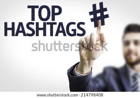Business man pointing to transparent board with text: Top Hashtags