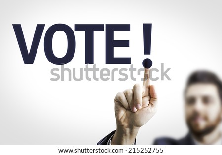 Business man pointing to transparent board with text: Vote!