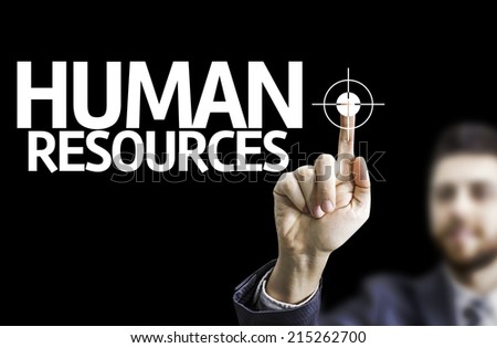 Business man pointing to black board with text: Human Resources